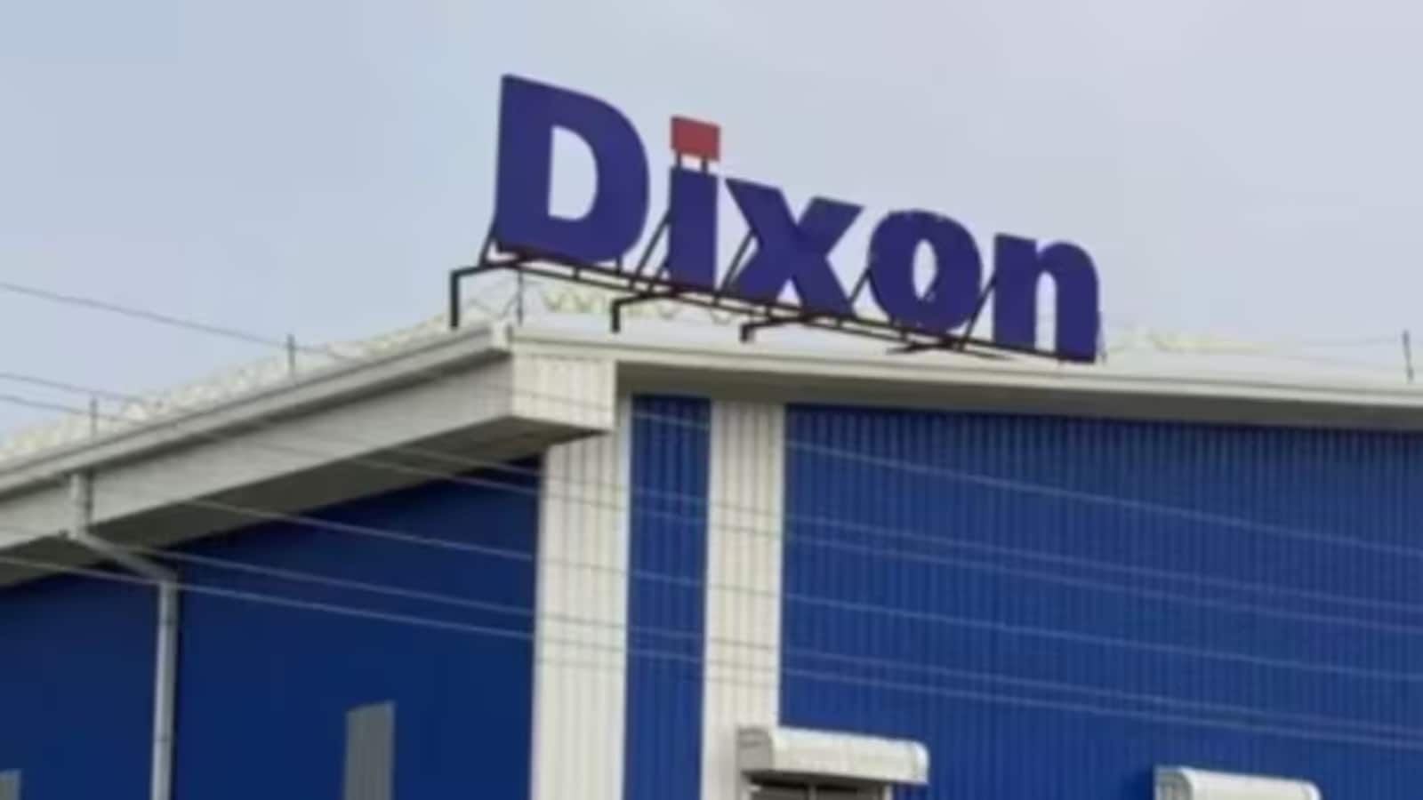 Dixon Tech Share Price : करीब 3% टूटा शेयर, स्टॉक पर नुवामा की रिपोर्ट ने बनाया दबाव